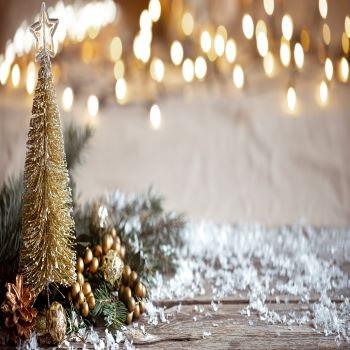 winter-cozy-background-with-festive-decor-details-snow-on-wooden-table-and-bokeh-the-concept-of-festive-atmosphere-at-home